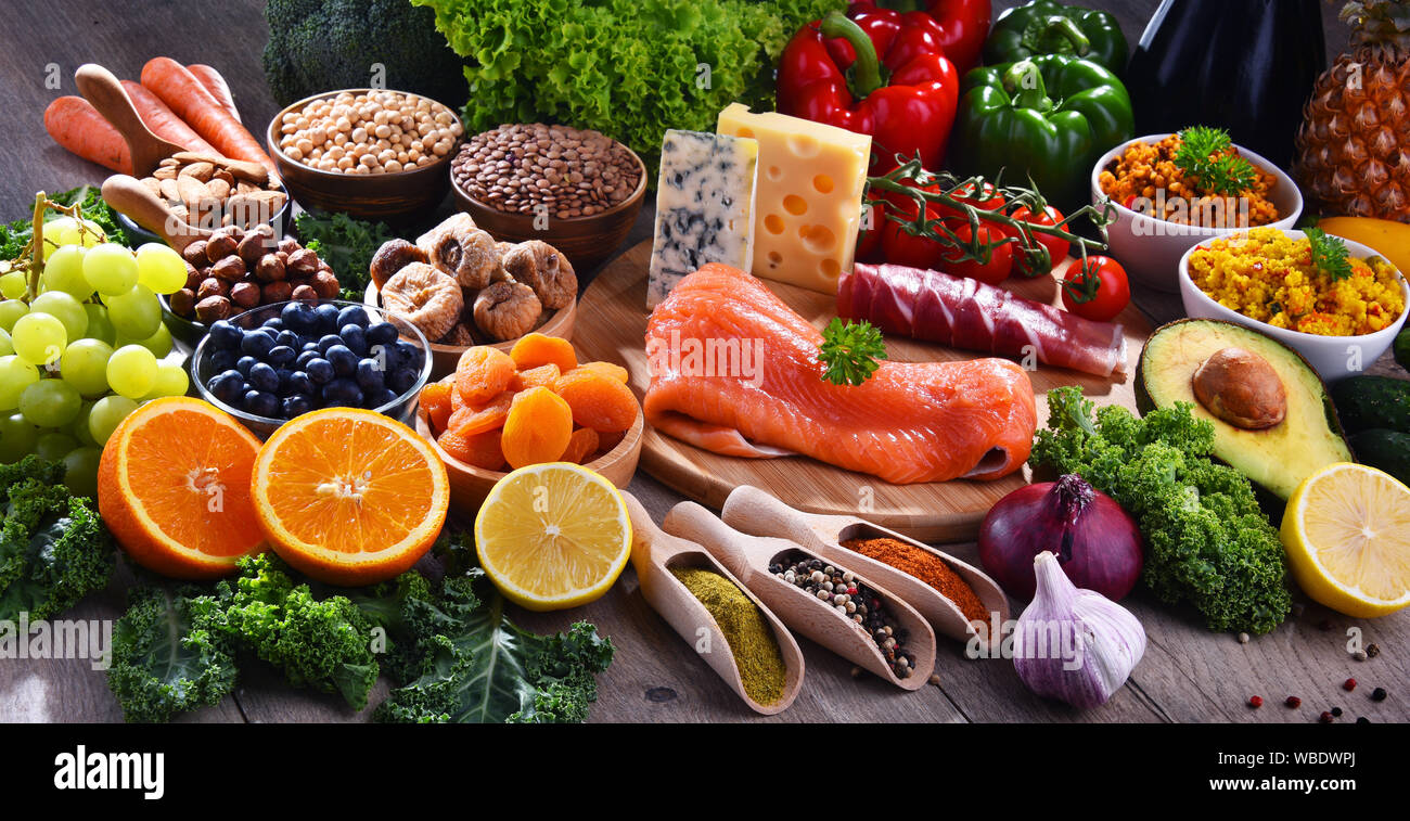 Composition with assorted food products on kitchen table Stock Photo ...