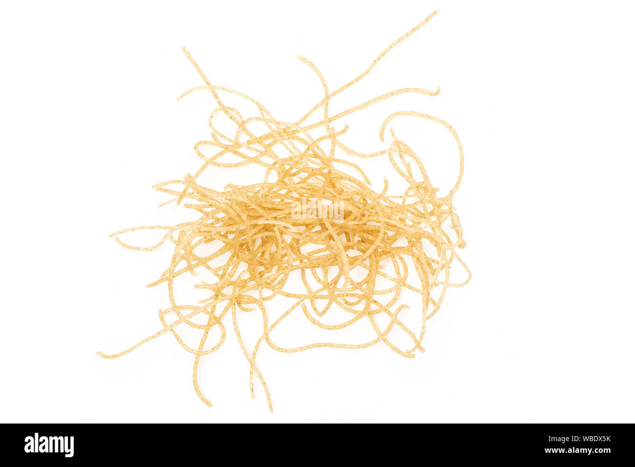 Lot of pieces of thin raw pasta noodles small heap flatlay isolated on