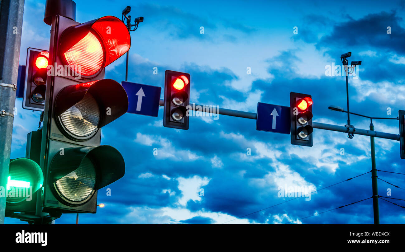 Traffic lights over urban intersection. Red light Stock Photo
