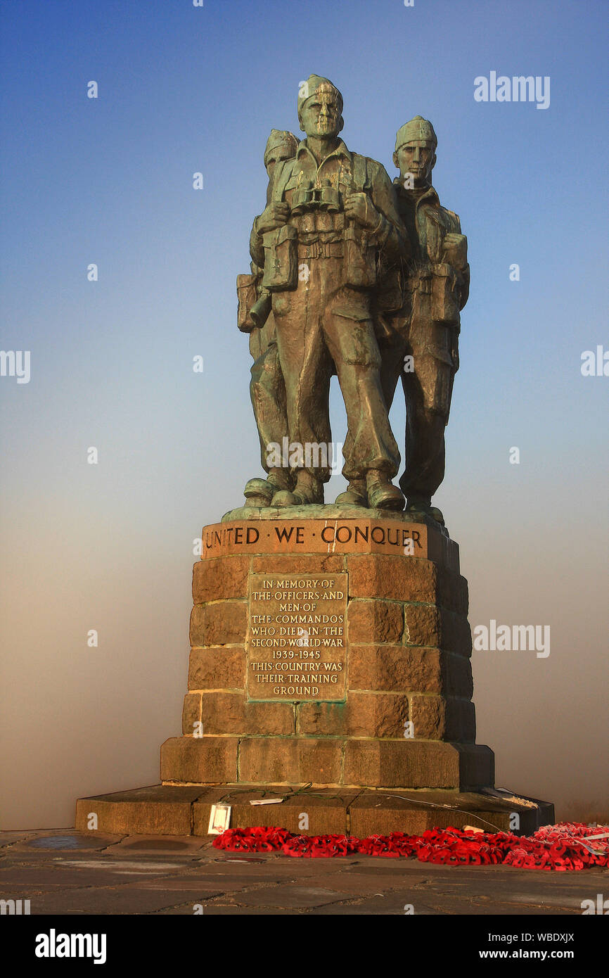 The plinth of the memorial records the Commando's motto 'United We Conquer', and a plaque states: 'In Memory of the Officers and men of the Commandos Stock Photo