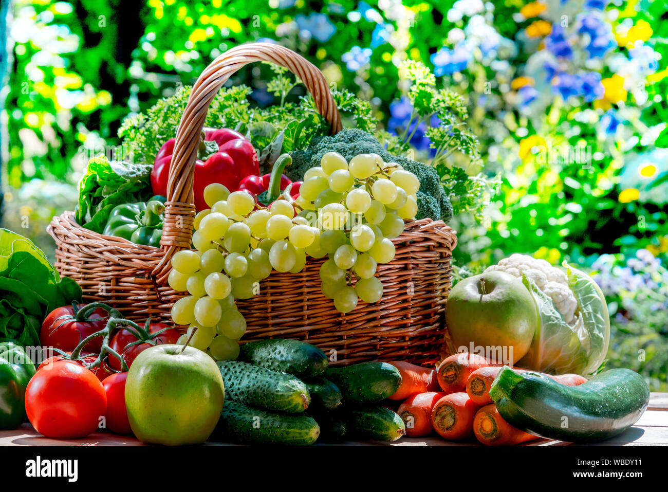 Variety of fresh organic vegetables and fruits in the garden. Balanced ...