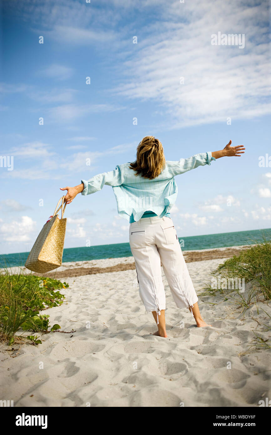 Mature woman beach arms hi-res stock photography and images - Alamy