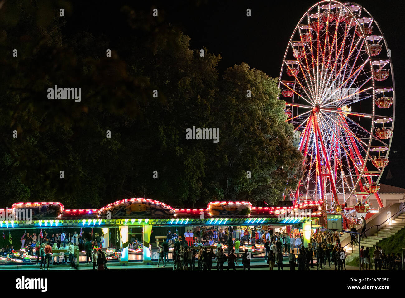 Stadtfest Brugg 24th of august 2019. street photography. Lunapark at night with illuminated spinning wheel and autosooter in Brugg. Stock Photo