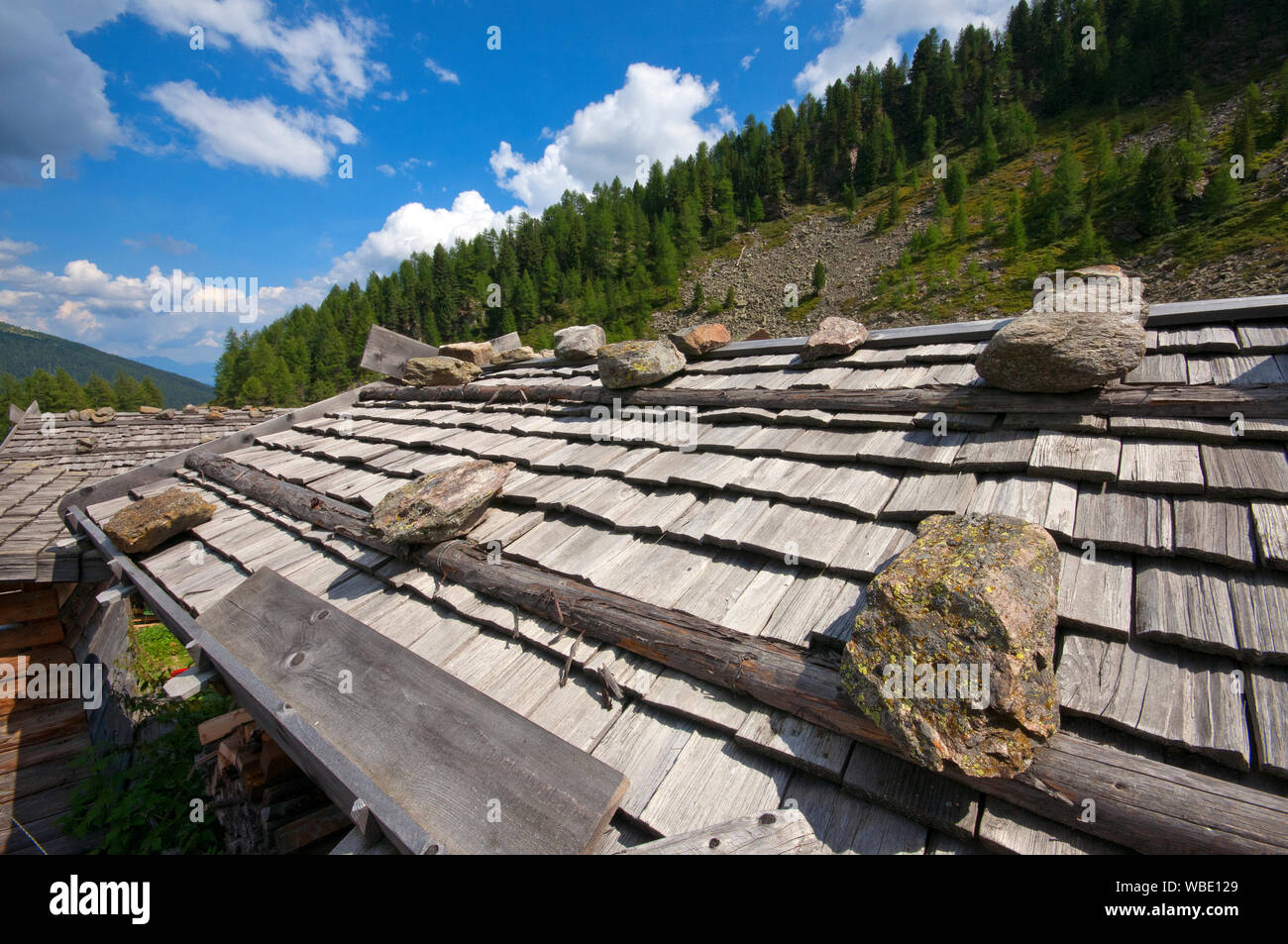 Traditional wooden roof with stones in Val d'Ultimo (Ultental), Bolzano, Trentino Alto Adige, Italy Stock Photo