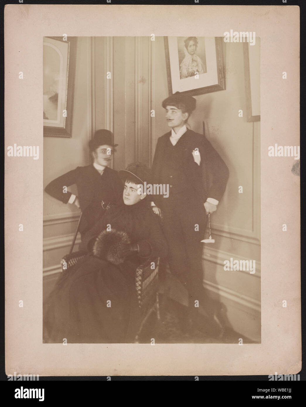 Frances Benjamin Johnston, full lgth., standing, in costume, wearing mustache, posed with 2 other people Abstract/medium: 1 photographic print mounted on layered paper : albumen ; photo 21 x 15 cm, on mount 25.3 x 20.3 cm. Stock Photo