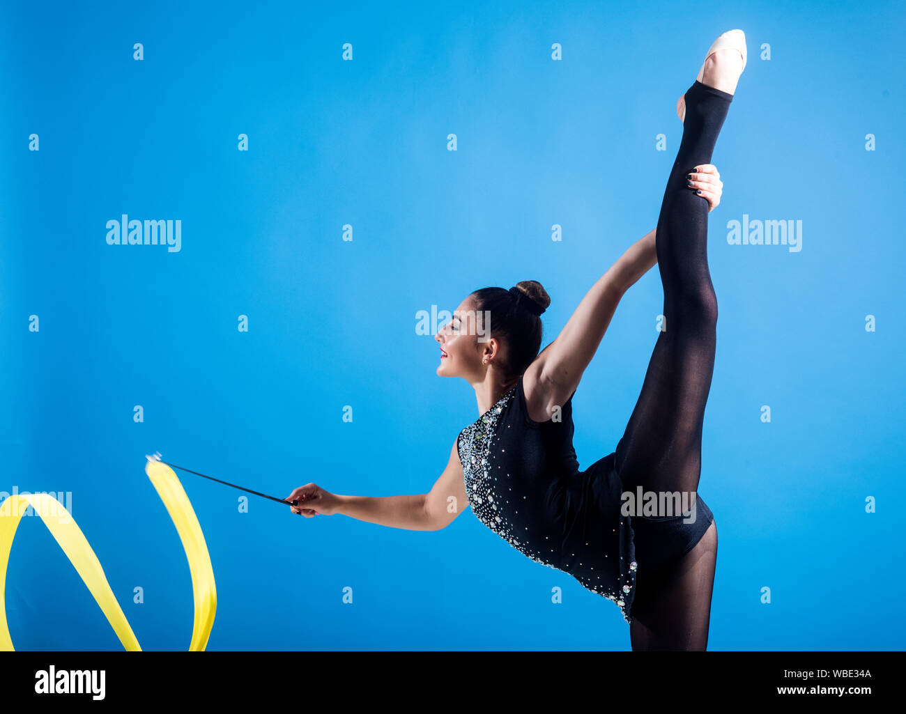 Fitness and dieting of girl gymnast. Woman train acrobatics with ribbon