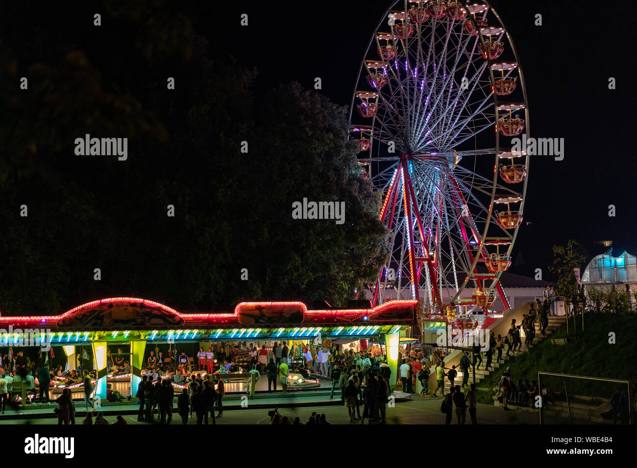 Stadtfest Brugg 24th of august 2019. street photography. Lunapark at night with illuminated spinning wheel and autosooter in Brugg. Stock Photo