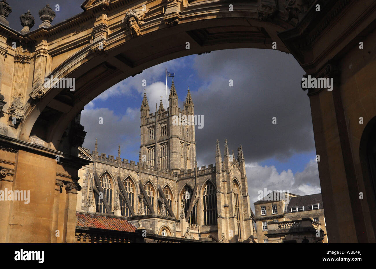 Bath Abbey framed by the ornate York Street stone arch with lowering sky behind.Bath, Somerset. England.UK Stock Photo