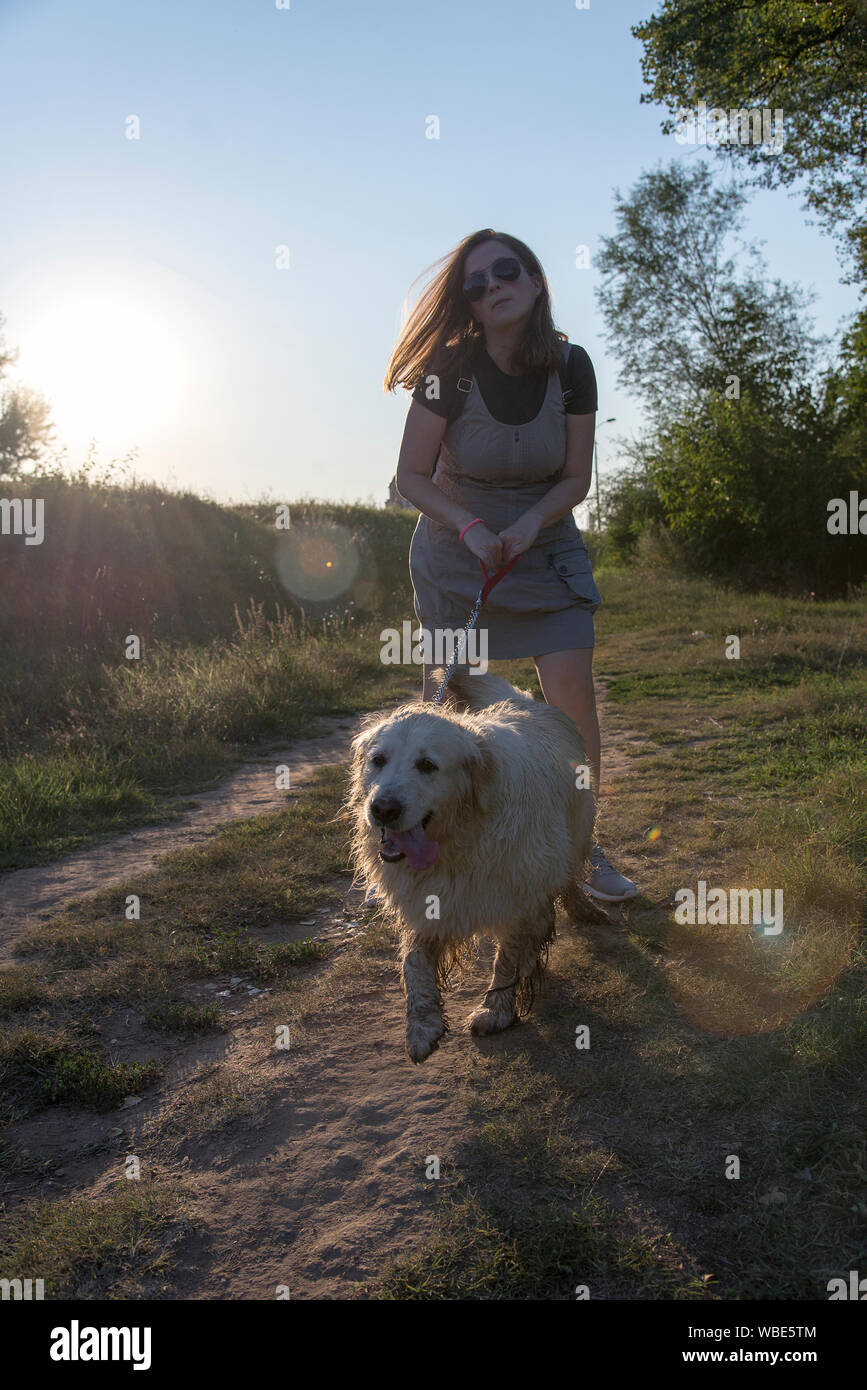 Woman and dog walking outdoor Stock Photo