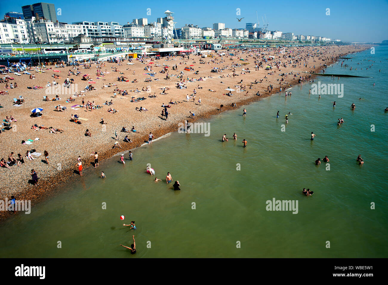People flock to the beach in Brighton to sunbathe and swim in the record- breaking hot temperatures of summer 2019. Stock Photo