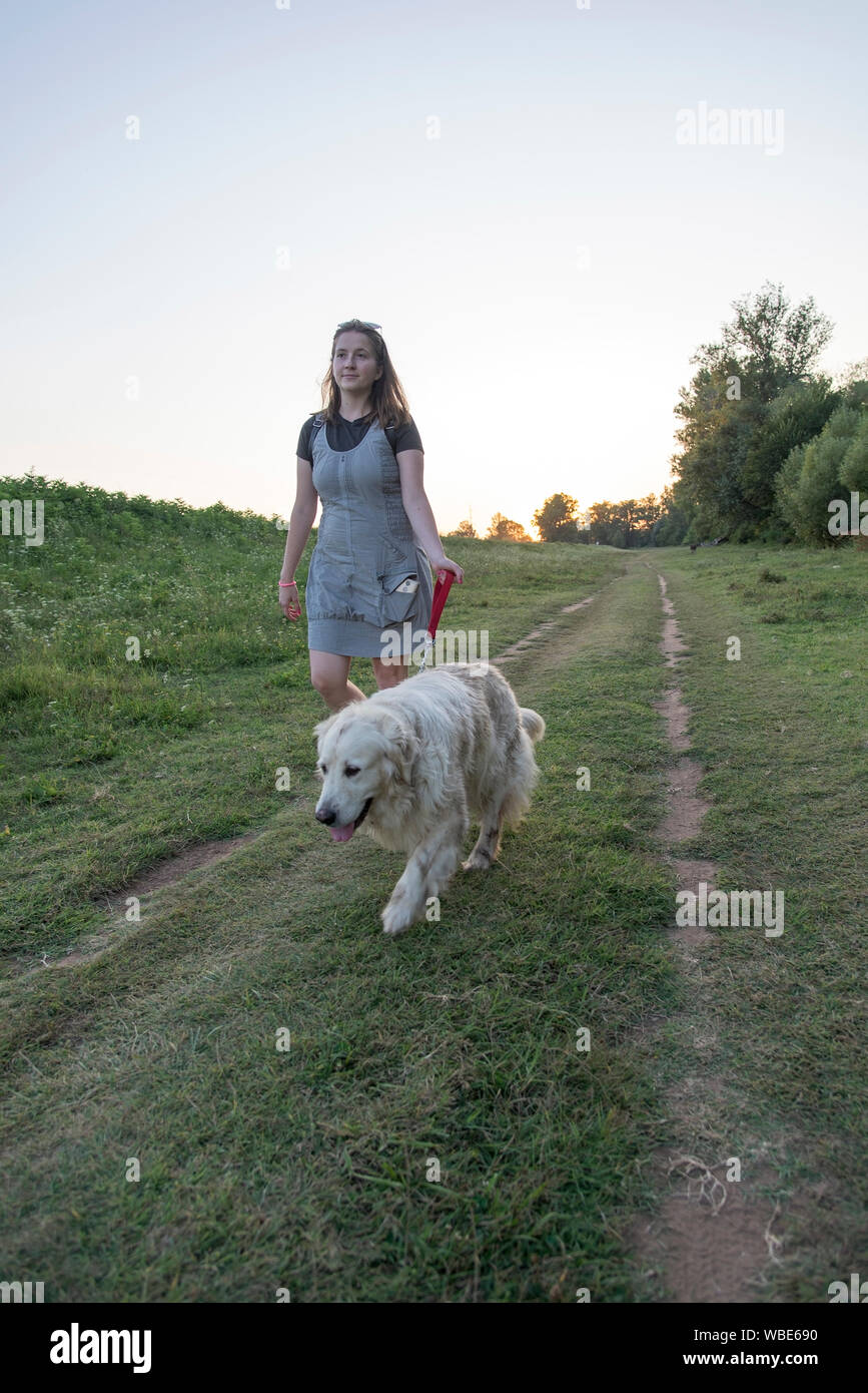 Woman and dog walking outdoor Stock Photo