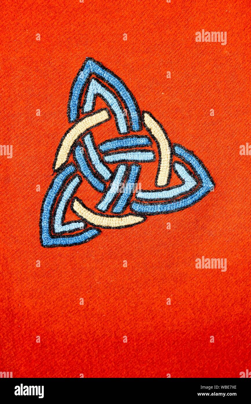Interlaced triquetra symbol on a red blanket Stock Photo