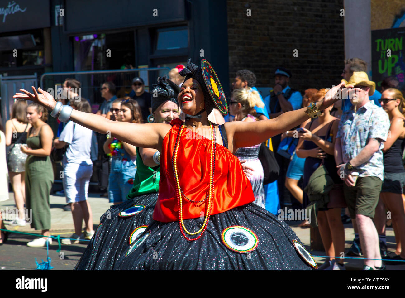 26 August 2019 - Woman in a costume walking in the Notting Hill Carnival parade on a hot Bank Holiday Monday, London, UK Stock Photo