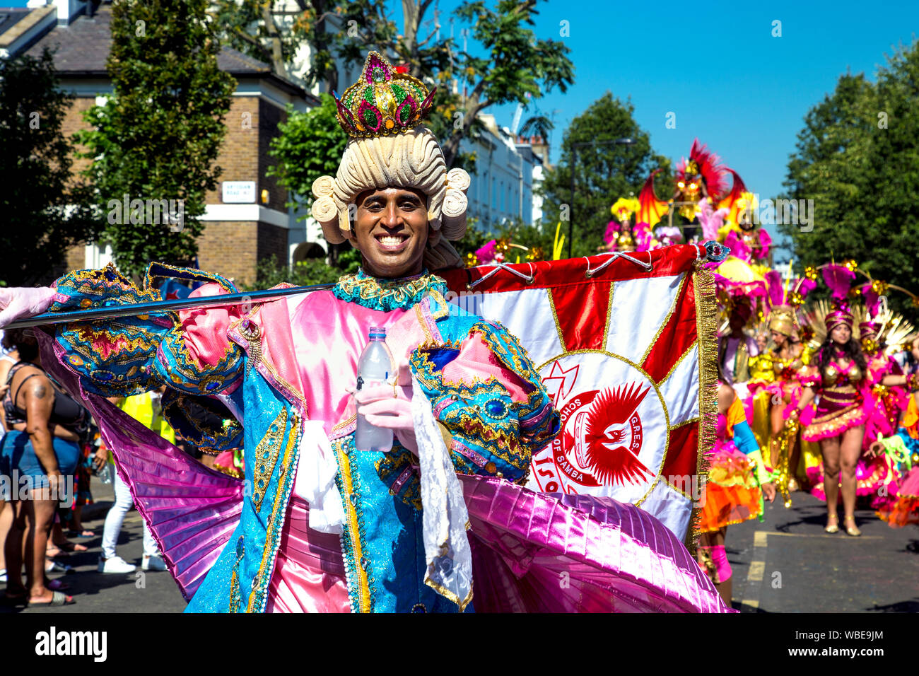 26 August 2019 - Man dressed up in a period costume with powder wig, crown and flag at Notting Hill Carnival on a hot Bank Holiday Monday, London, UK Stock Photo