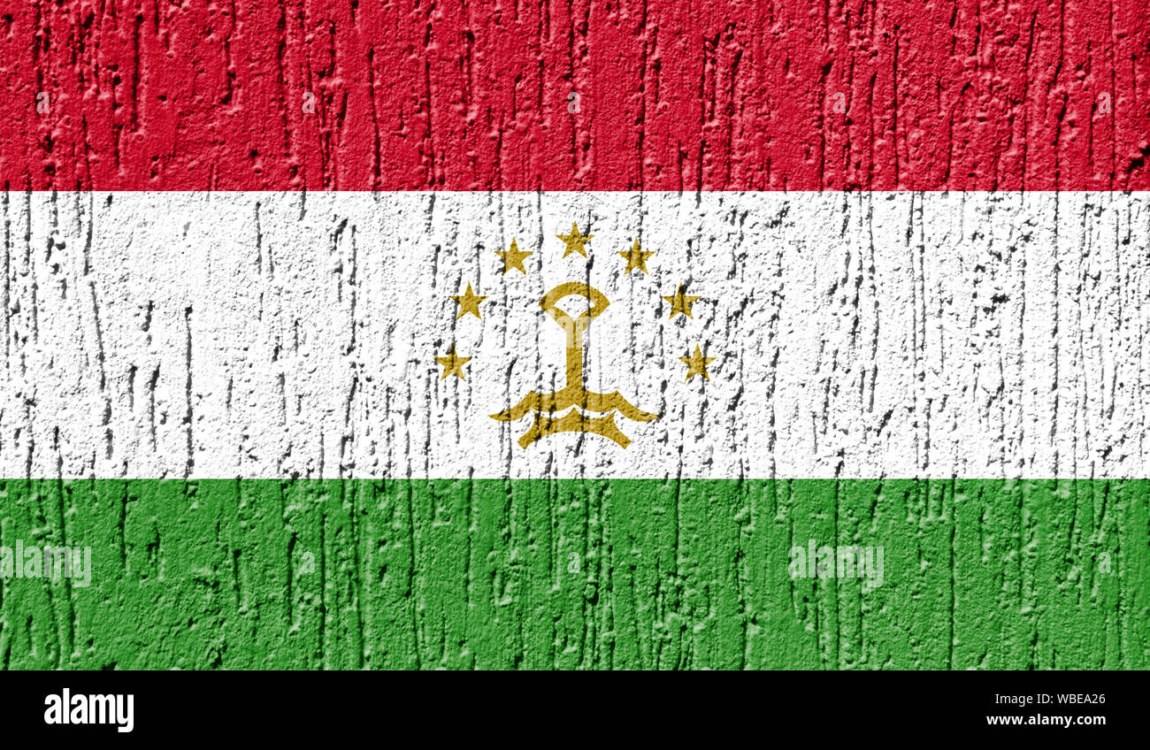 Flag of Tajikistan close up painted on a cracked wall Stock Photo
