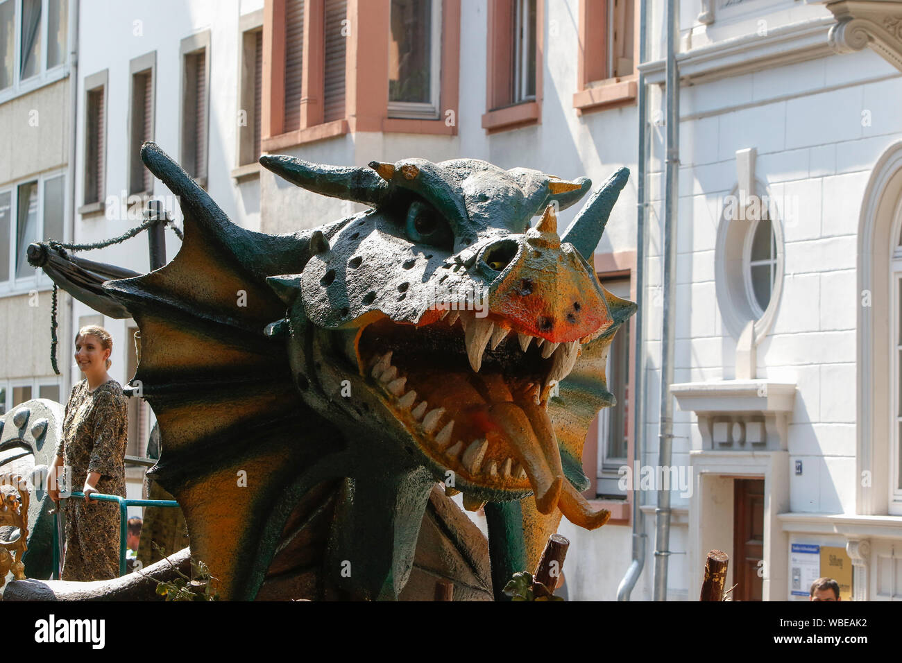 Worms, Germany. 25th August 2019. A dragon's head, the dragon is a symbol for the city of Worms, is pictured on a float. The first highlight of the 2019 Backfischfest was the big parade through the city of Worms with over 70 groups and floats. Community groups, music groups and businesses from Worms and further afield took part. Stock Photo