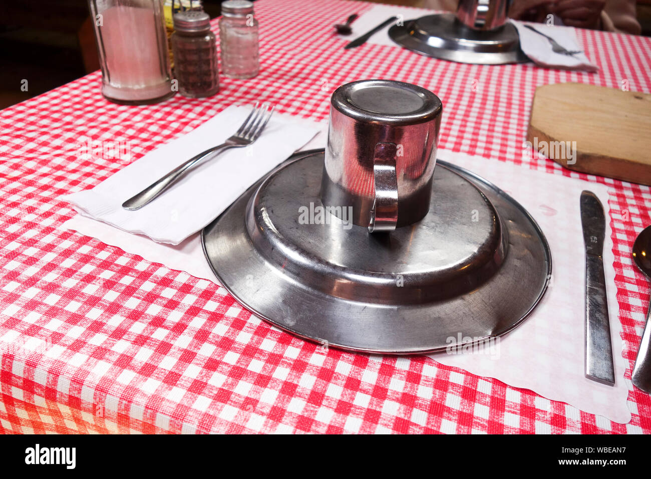 Table setting with metal plate and cup upside down Stock Photo Alamy