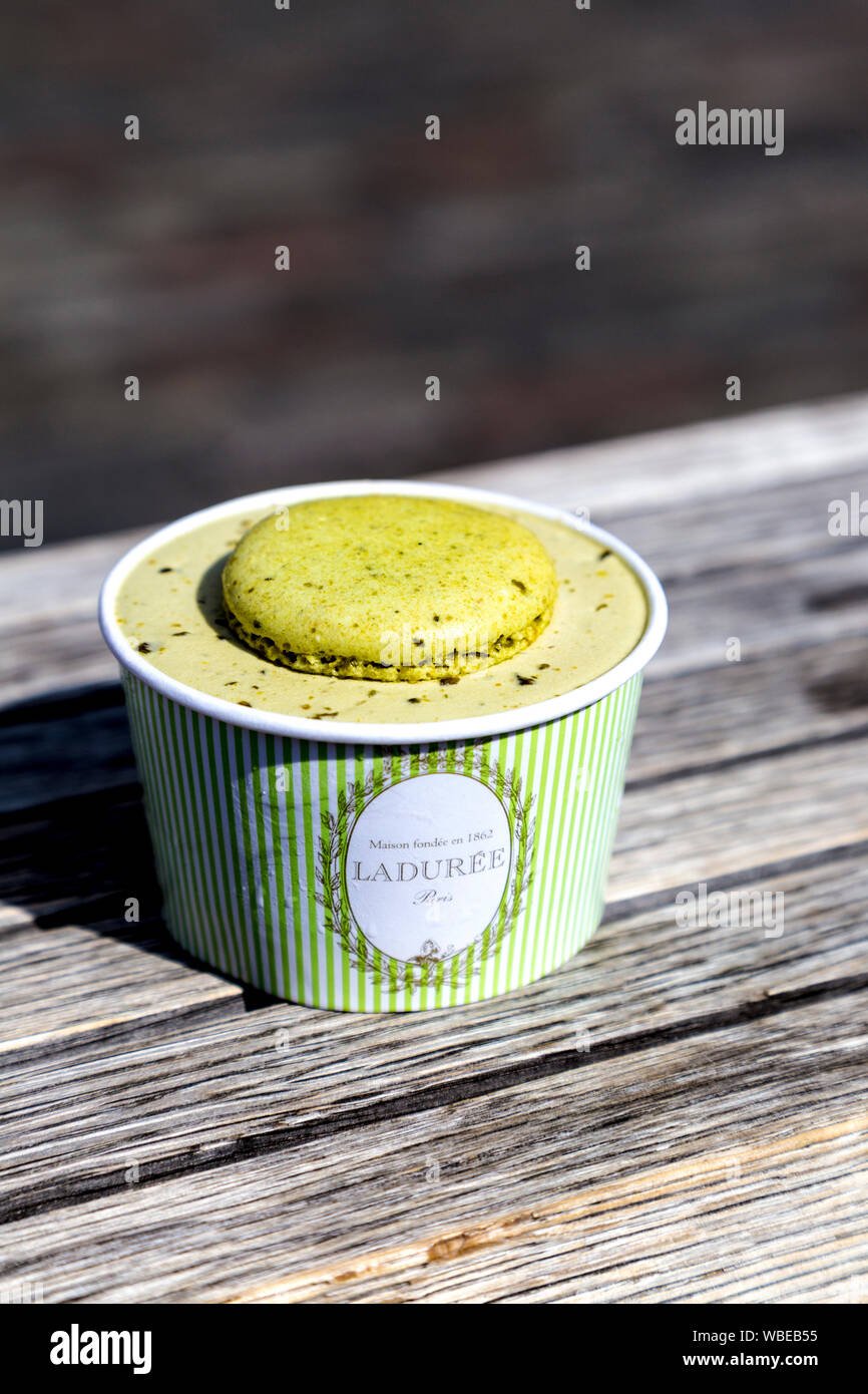 Cup of pistachio ice cream by Laduree with a macaron on top, Covent Garden Cool Down, London, UK Stock Photo
