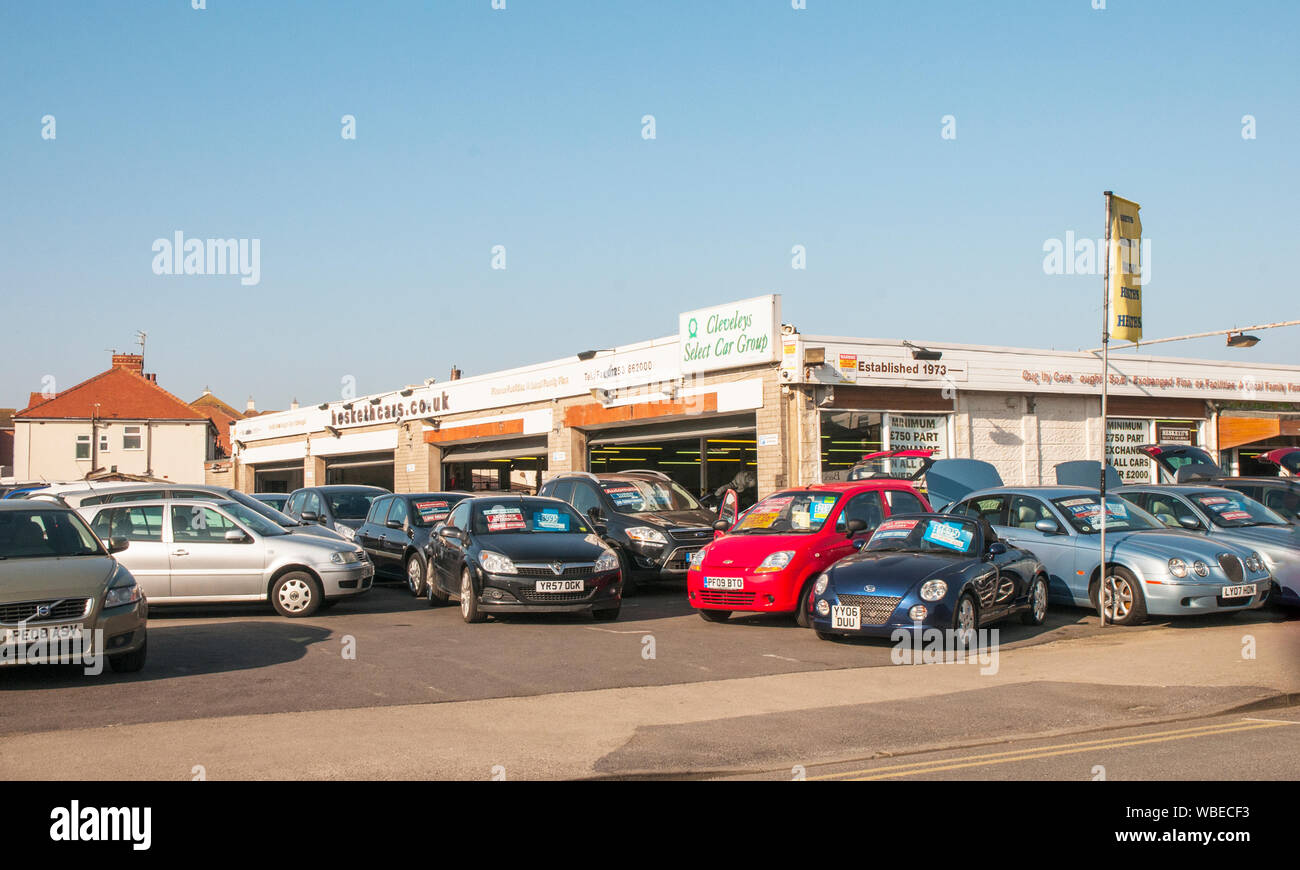 Cars for sale on car lot outside showroom Stock Photo