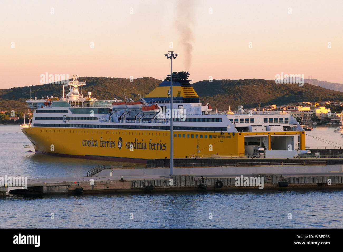 Livorno, Italy - August 3, 2019: Yellow ferry carrying passengers and means of transport connecting Italy with the island of Sardinia. Stock Photo