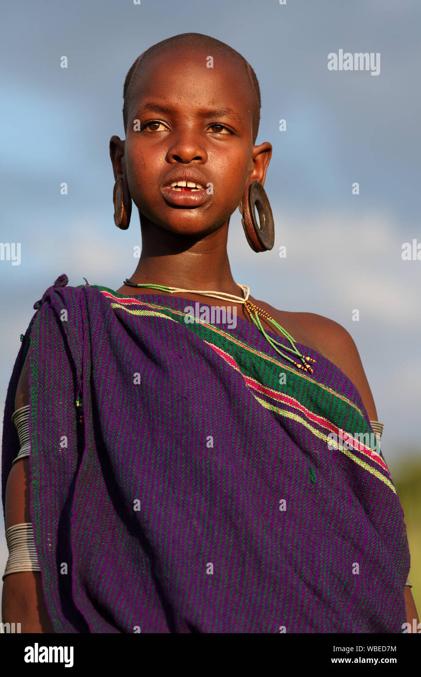 Beautiful tribal Suri girl at a ceremony in Lower Omo Valley near Kibish, Ethiopia Stock Photo
