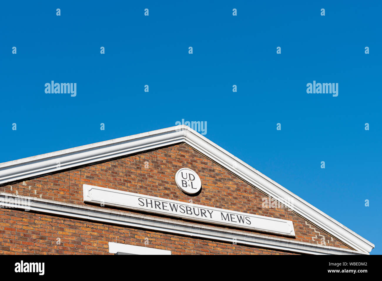 Shrewsbury Mews, Notting Hill, London W2. Property building decoration sign. UD B&L. Blue sky. Space for copy Stock Photo