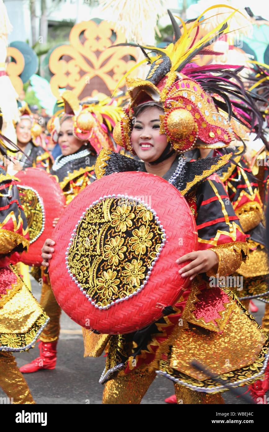 Davao City, PhilippinesAugust 2014 Performers in colorful costumes dance in the street at the