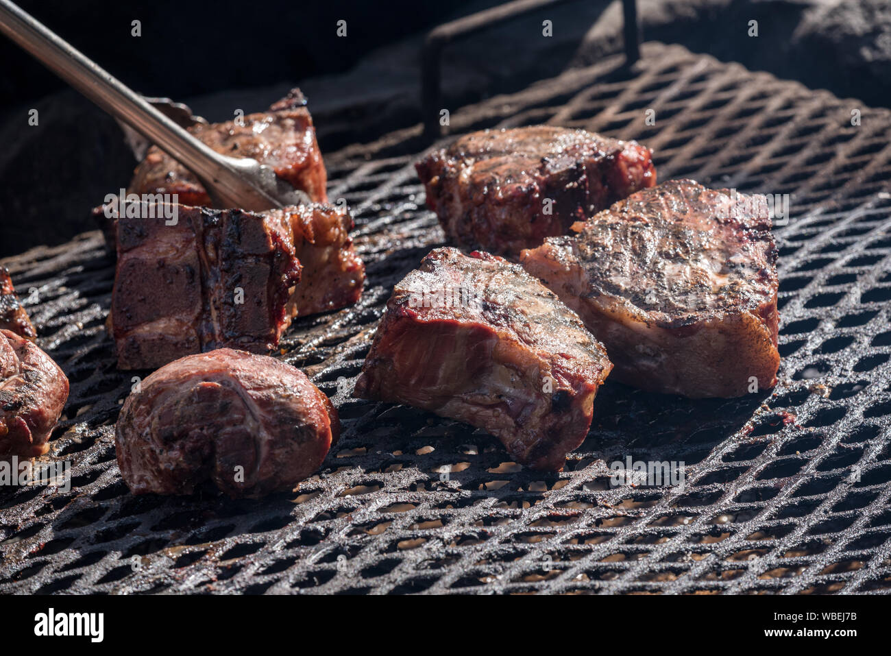 Meat cooking over a wood fire at the Minam River Lodge in Oregon's Wallowa Mountains. Stock Photo
