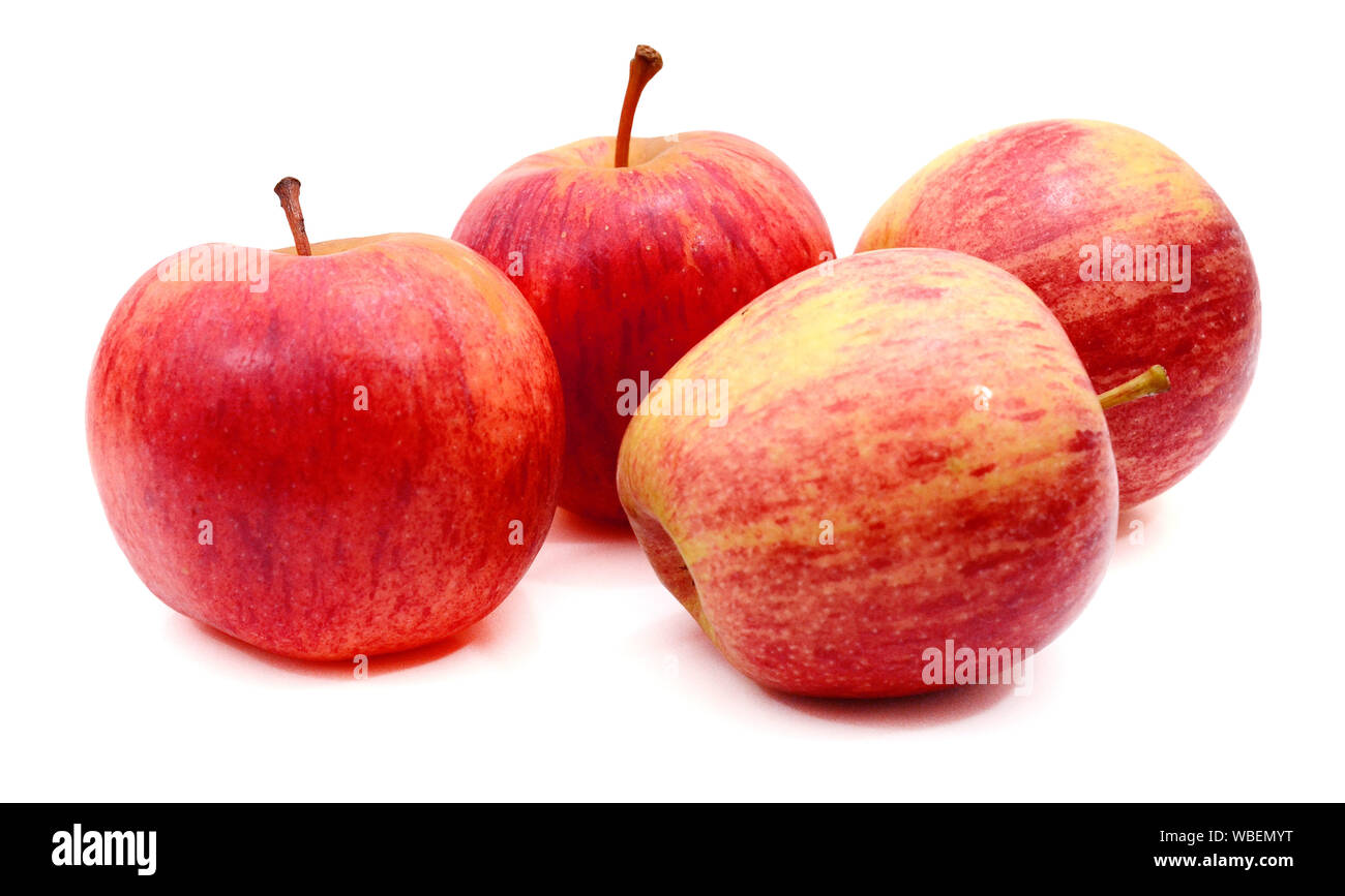 Four red apples with water droplets on white background, focus on the middle apple Stock Photo