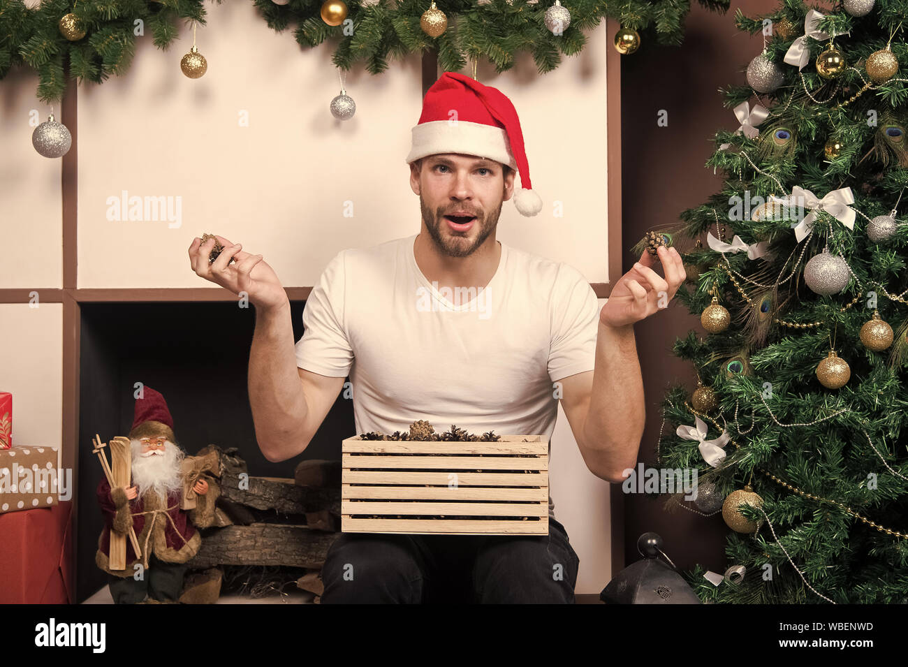 The morning before Xmas. delivery christmas gifts. happy santa man. online  christmas shopping. New year scene with tree & gift. man in santa hat hold  christmas present. Merry Christmas. what is this