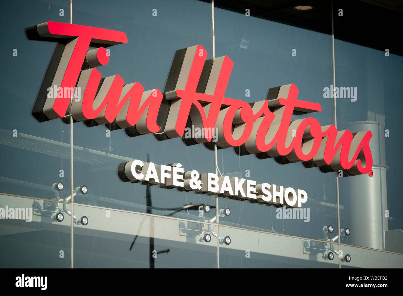 Signage indicating a drive thru branch of the Tim Hortons cafe and bake shop located on Bury New Road in Manchester, UK. Stock Photo
