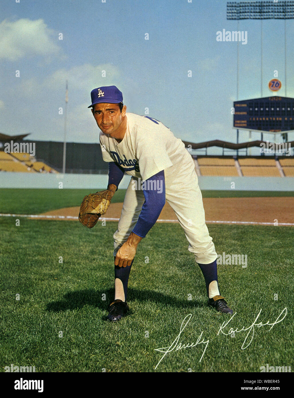 Sandy Koufax, the star pitcher  for the Los Angeles Dodgers throughout the 1960s poses for a souvenir photo on the field of the newly opened Dodger Stadium circa 1962. Stock Photo