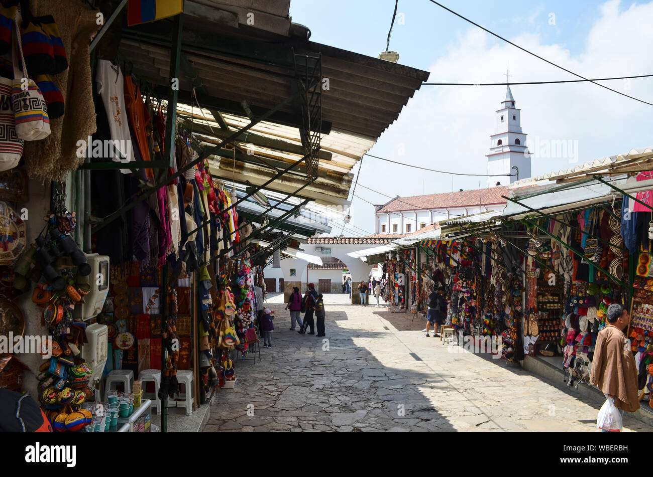 BOGOTA, COLOMBIA - JANUARY 25, 2014: Craft shops at the top of Monserrate and view of the Basilica of the Lord of Monserrate. Stock Photo