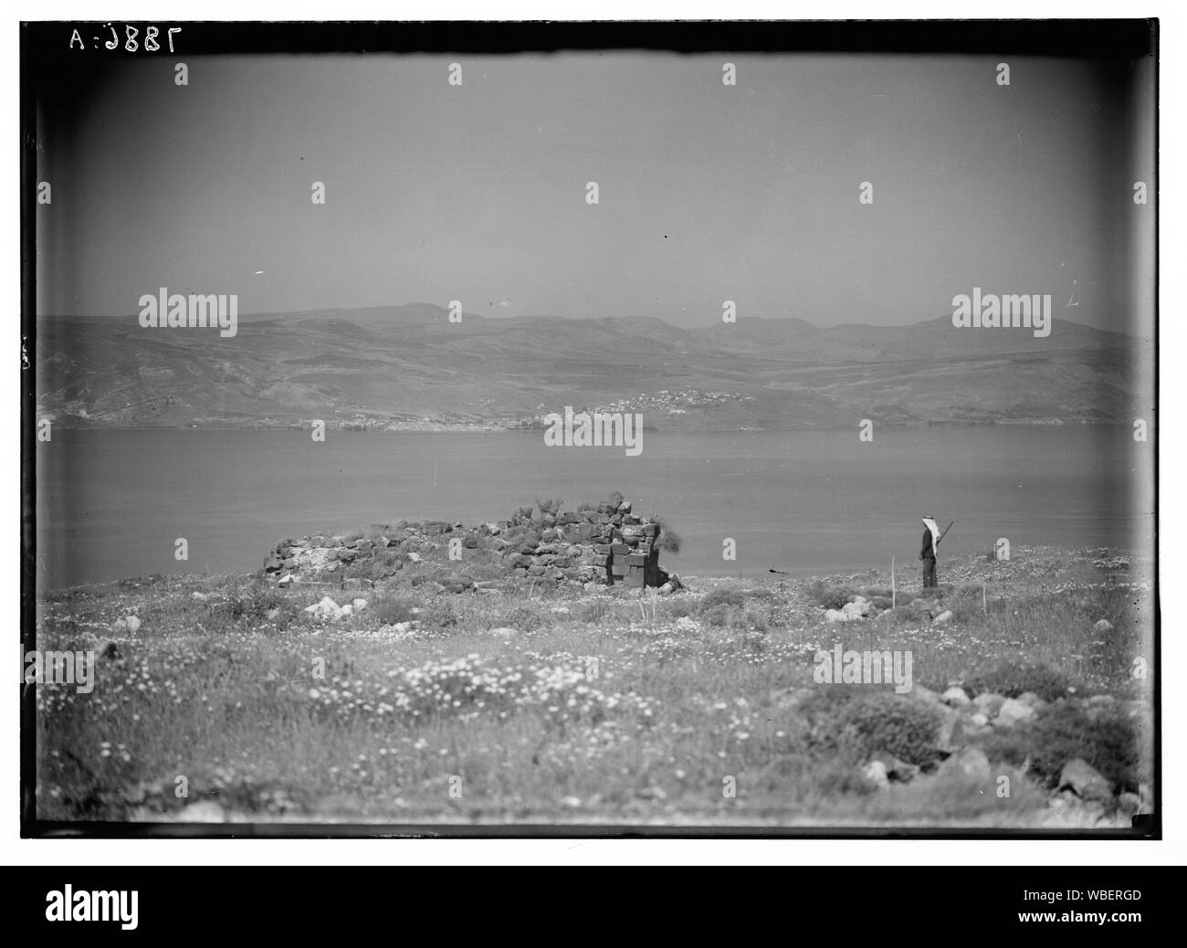 Gamala (Kal'at el-Huson, east of the Sea of Galilee). View from the summit of the hill showing Tiberias across the Lake & ruins of fortress in foreground Abstract/medium: G. Eric and Edith Matson Photograph Collection Stock Photo