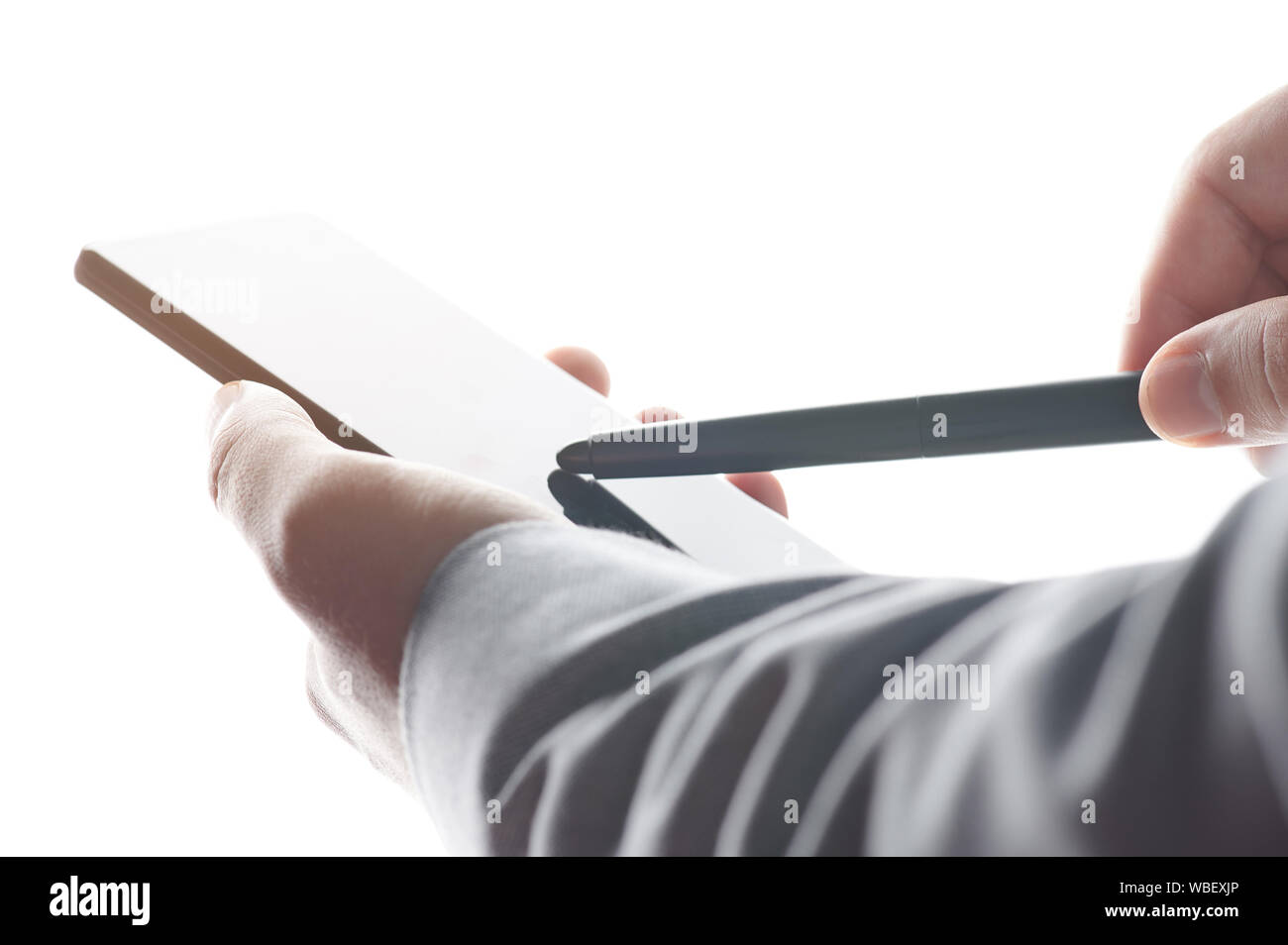 Man pointing with stylus on smartphone screen close up view Stock Photo
