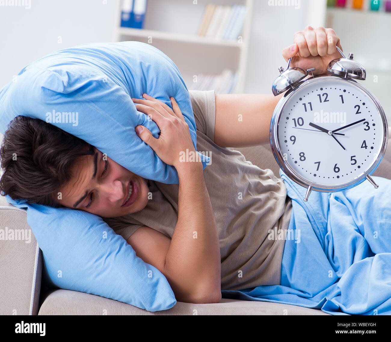 The man having trouble waking up with alarm clock Stock Photo Alamy