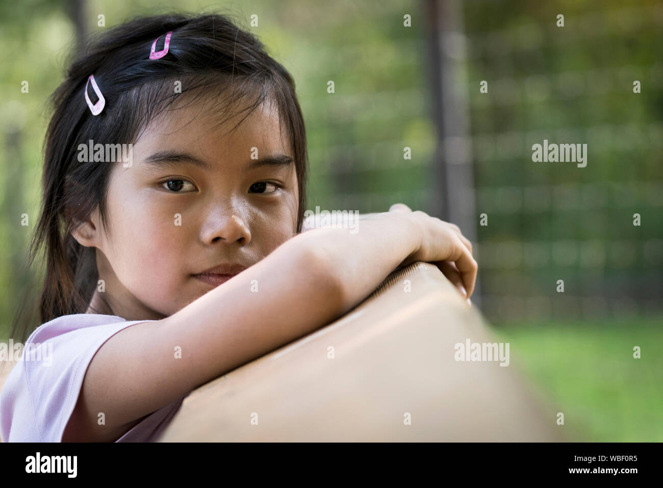 Little Asian girl looking at camera Stock Photo