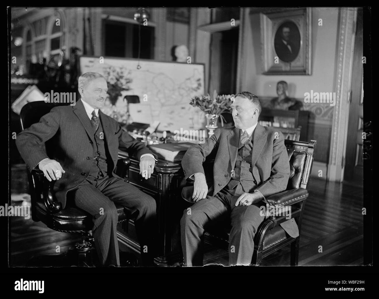 Gen. John J. Pershing, Chief of Staff, at his desk in the War Dept. for the first time since his return from France, conferring with Major Cen. John L. Hines, Deputy Chief of Staff Abstract/medium: 1 negative : glass ; 5 x 7 in. or smaller Stock Photo