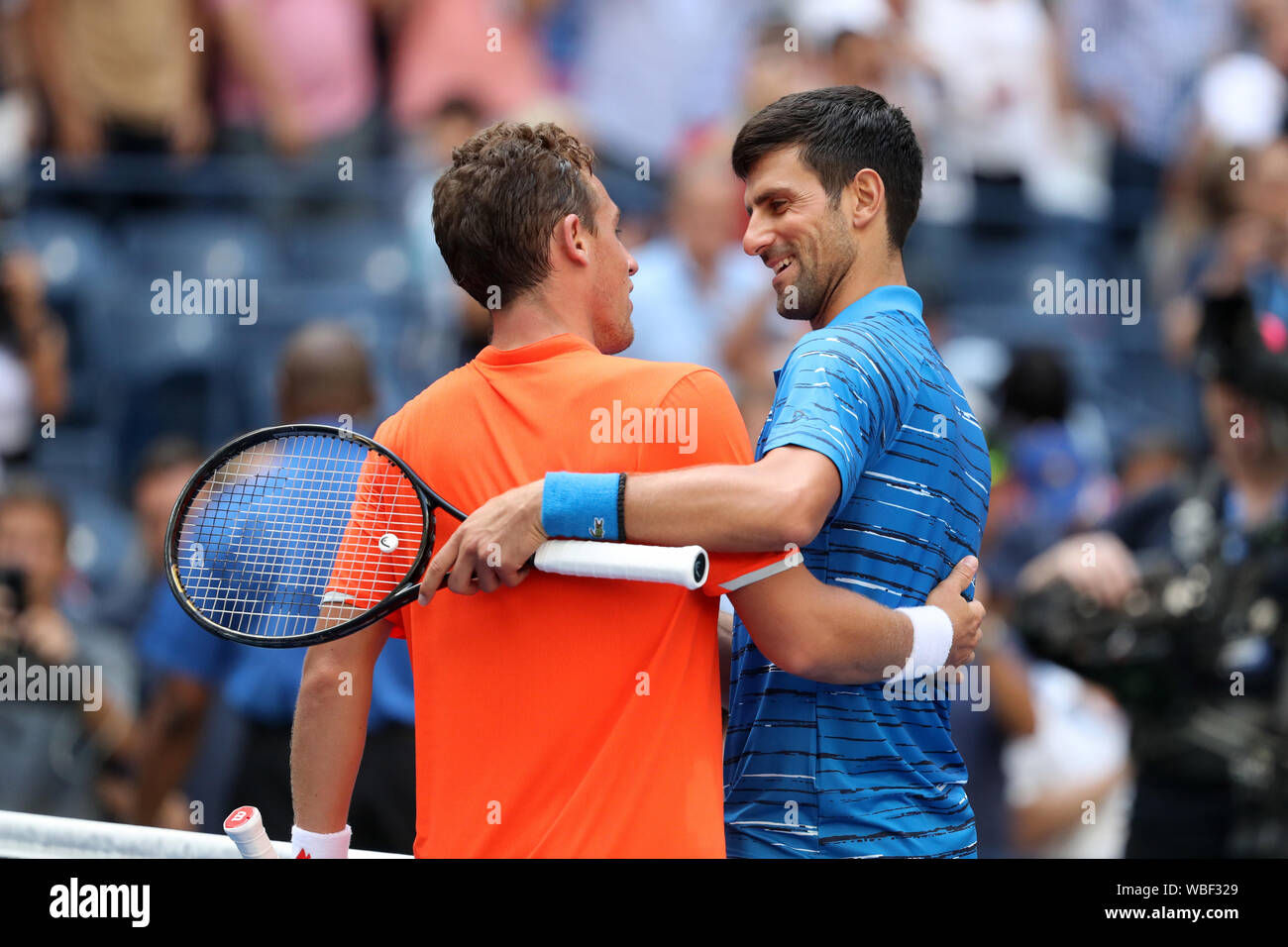 New York, USA. 26th Aug, 2019. Novak Djokovic (R) of Serbia talks to  Roberto Carballes Baena of Spain after the men's singles first round match  at the 2019 US Open in New