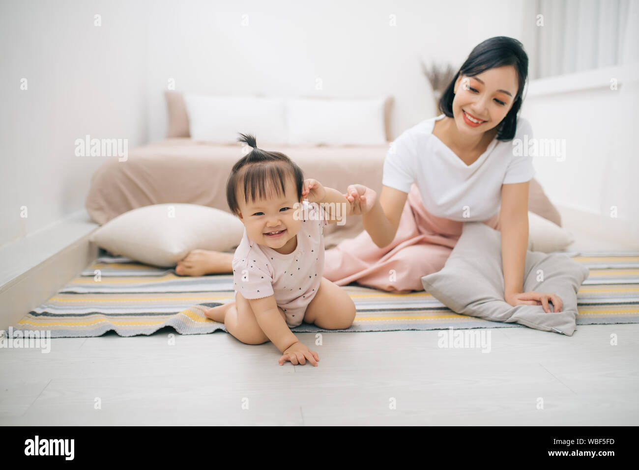 asian mother and child relaxing on the bed room Stock Photo