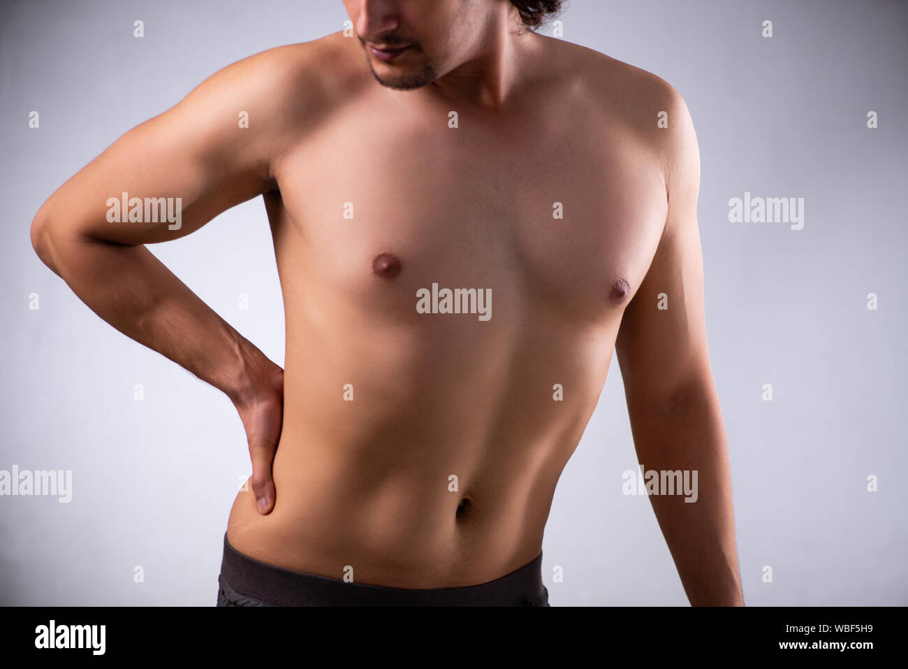 The man suffering from backbain on gray Stock Photo