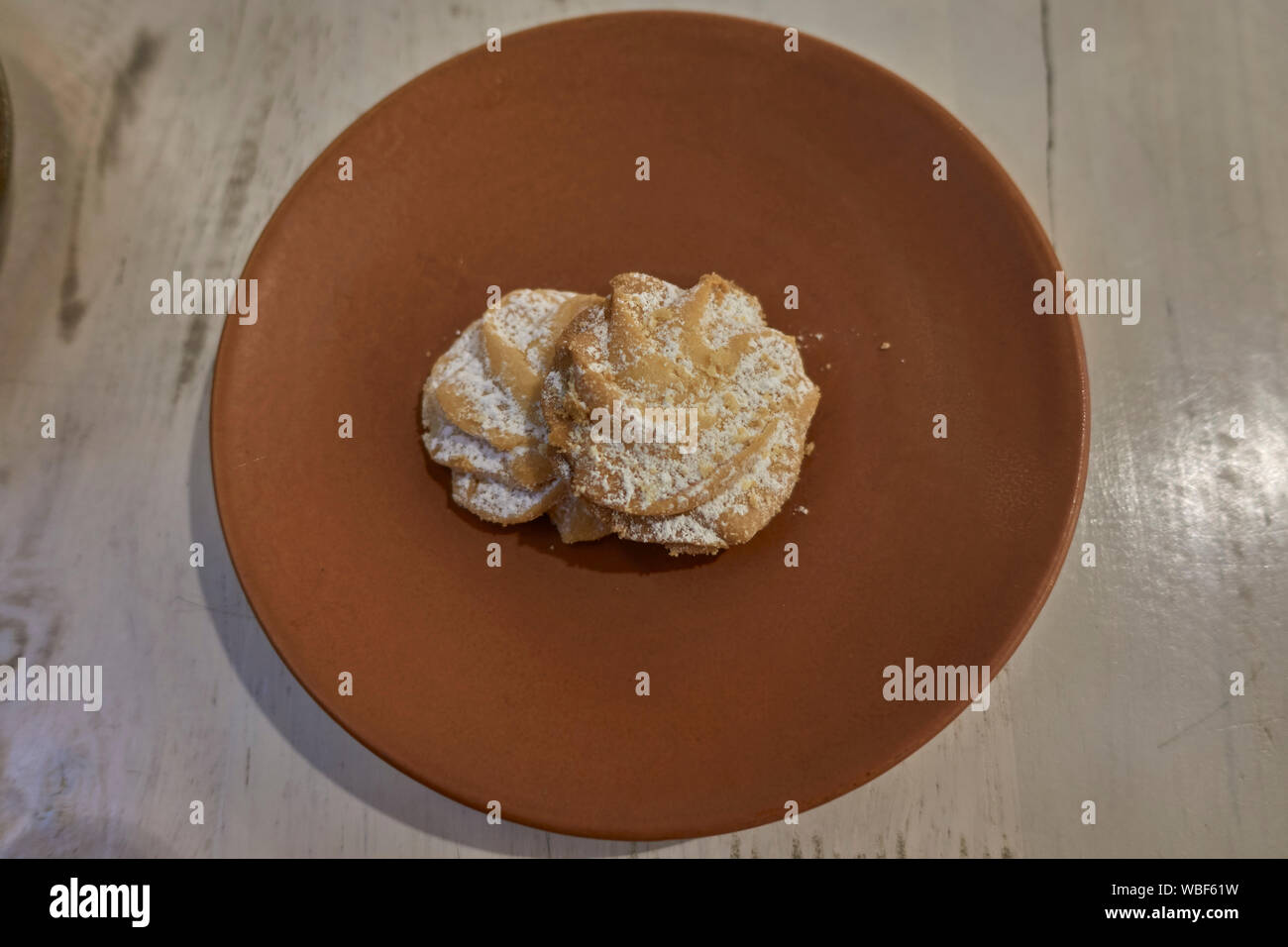 Viennese Whirl biscuits with sprinkled sugar coating on a plate served as a complement to coffee drink Stock Photo