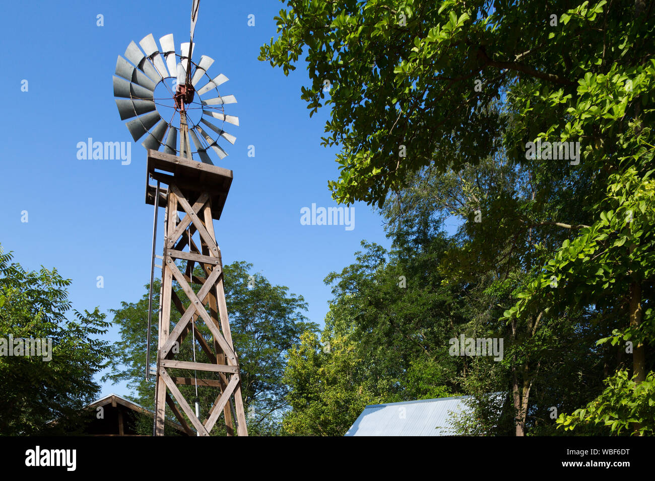 An antique windmill in the Indiana Family Farm Exhibit at the Fort Wayne Children's Zoo in Fort Wayne, Ind., USA. Stock Photo
