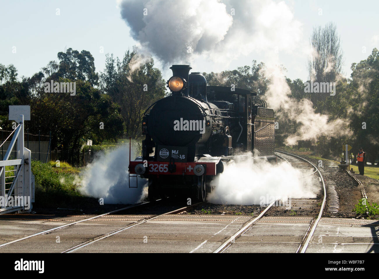 Restored steam train on railway tracks surrounded by clouds of steam at Thirlmere Railway Museum NSW Australia Stock Photo