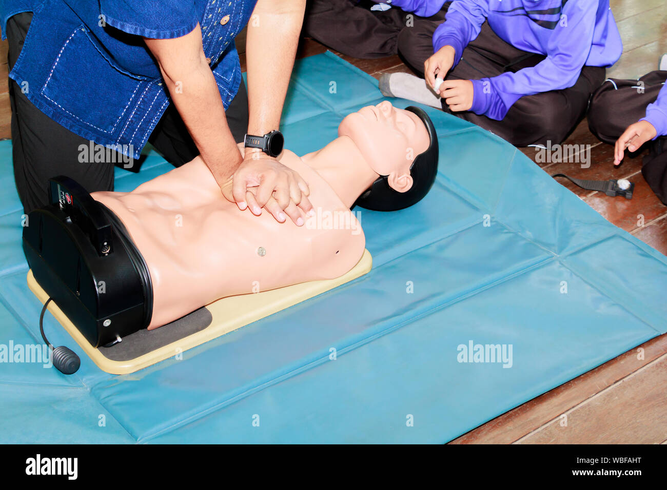 hand student Heart pump with medical dummy on CPR, in emergency refresher training to assist of physician Stock Photo