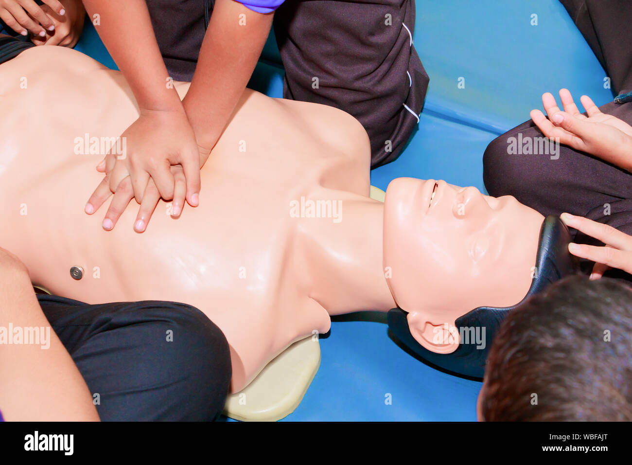 hand student Heart pump with medical dummy on CPR, in emergency refresher training to assist of physician Stock Photo