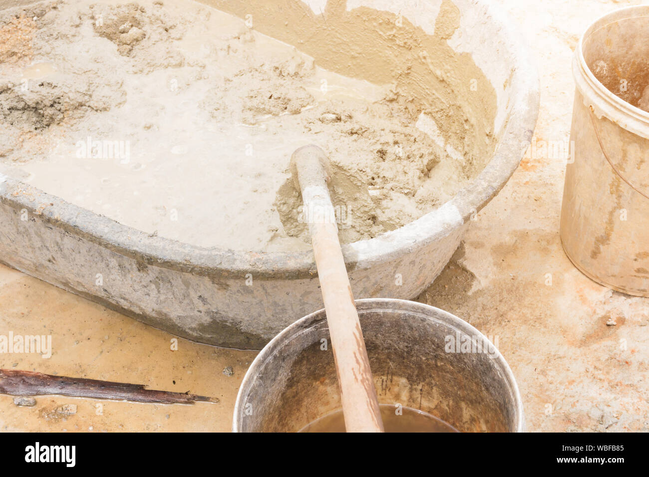 Bucket cement mix with on construction site the ingredients. Brick, Stone,  Mortar, Sand Stock Photo - Alamy