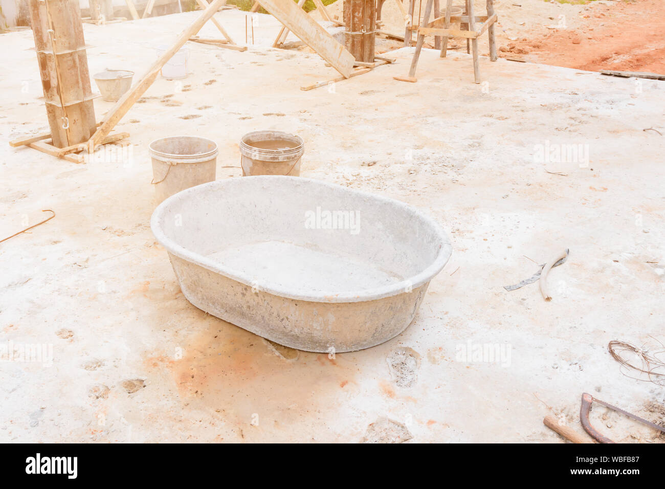 mortar in black plastic bucket cement mixer in workplace construction with copy space add text