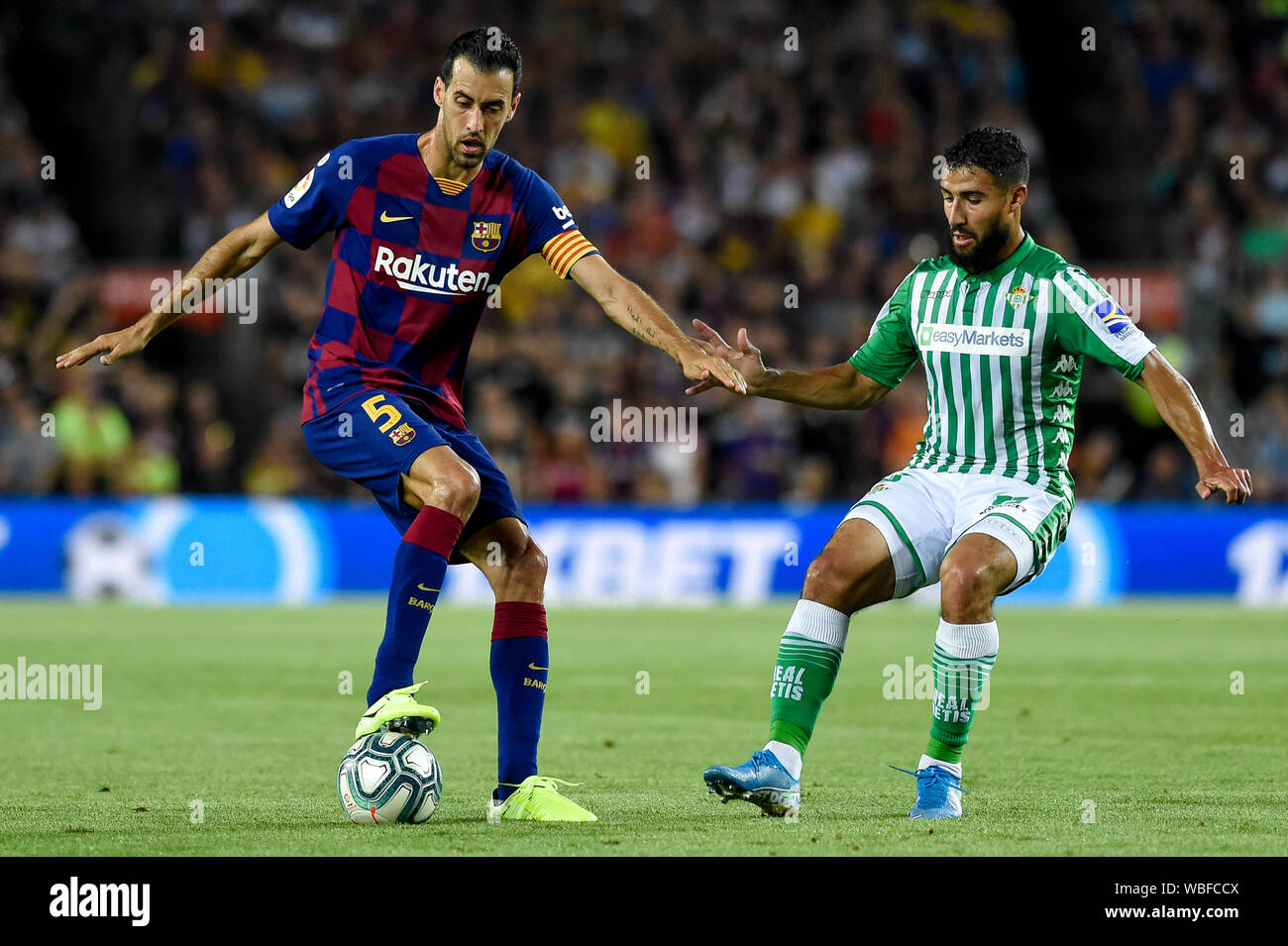 Barcelona, Spain. 26th Aug, 2019. BARCELONA, SPAIN - AUGUST 25: Sergio Busquets of FC Barcelona and Nabil Fekir of Real Betis during the La Liga match between FC Barcelona and Real Betis at Camp Nou on August 25 2019 in Barcelona, Spain. (Photo by David Ramirez/Pacific Press) Credit: Pacific Press Agency/Alamy Live News Stock Photo