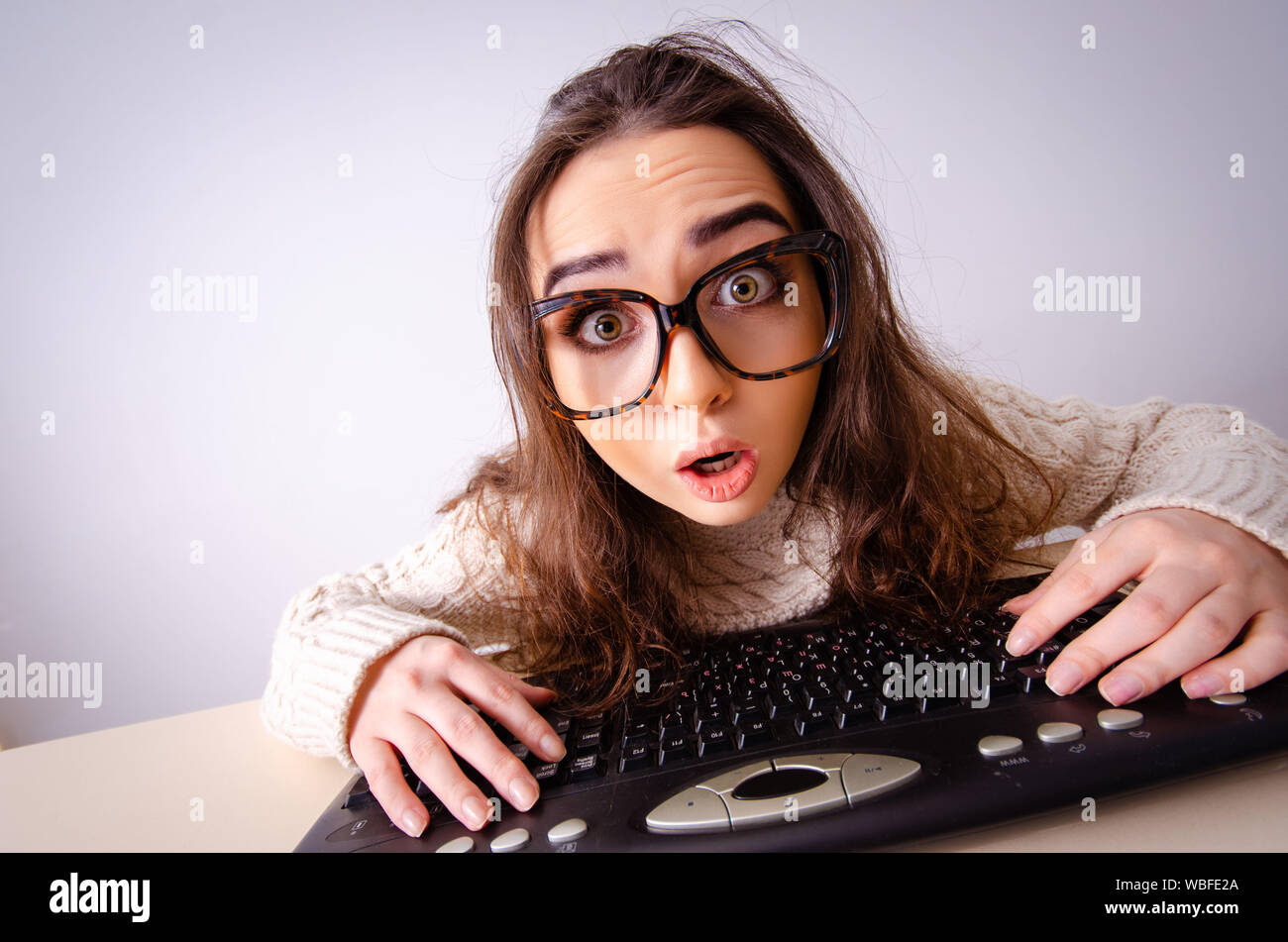 The funny nerd girl working on computer Stock Photo